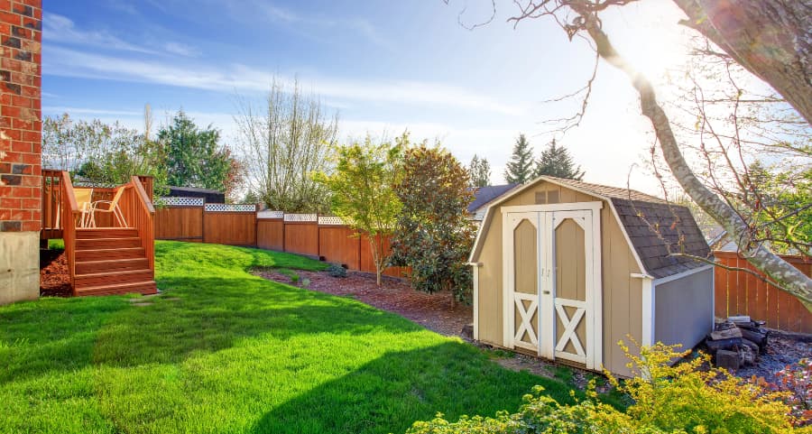 Fenced backyard with storage shed in Joplin